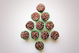 Cupcakes with sprinkles in the shape of a Christmas tree