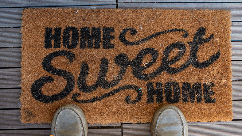 A doormat to a home owner's property reading 'Home sweet home'.