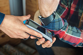 person uses digital watch to make eftpos payment