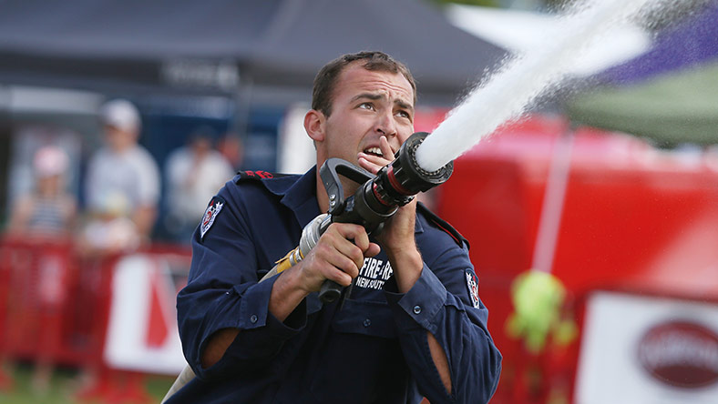 firefighter using firehose