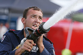 firefighter using firehose
