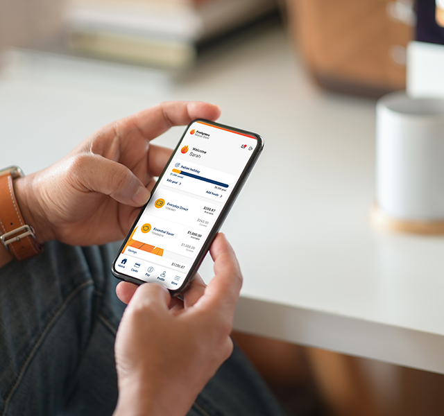 A woman looks at her accounts on the Firefighters Mutual Bank app.
